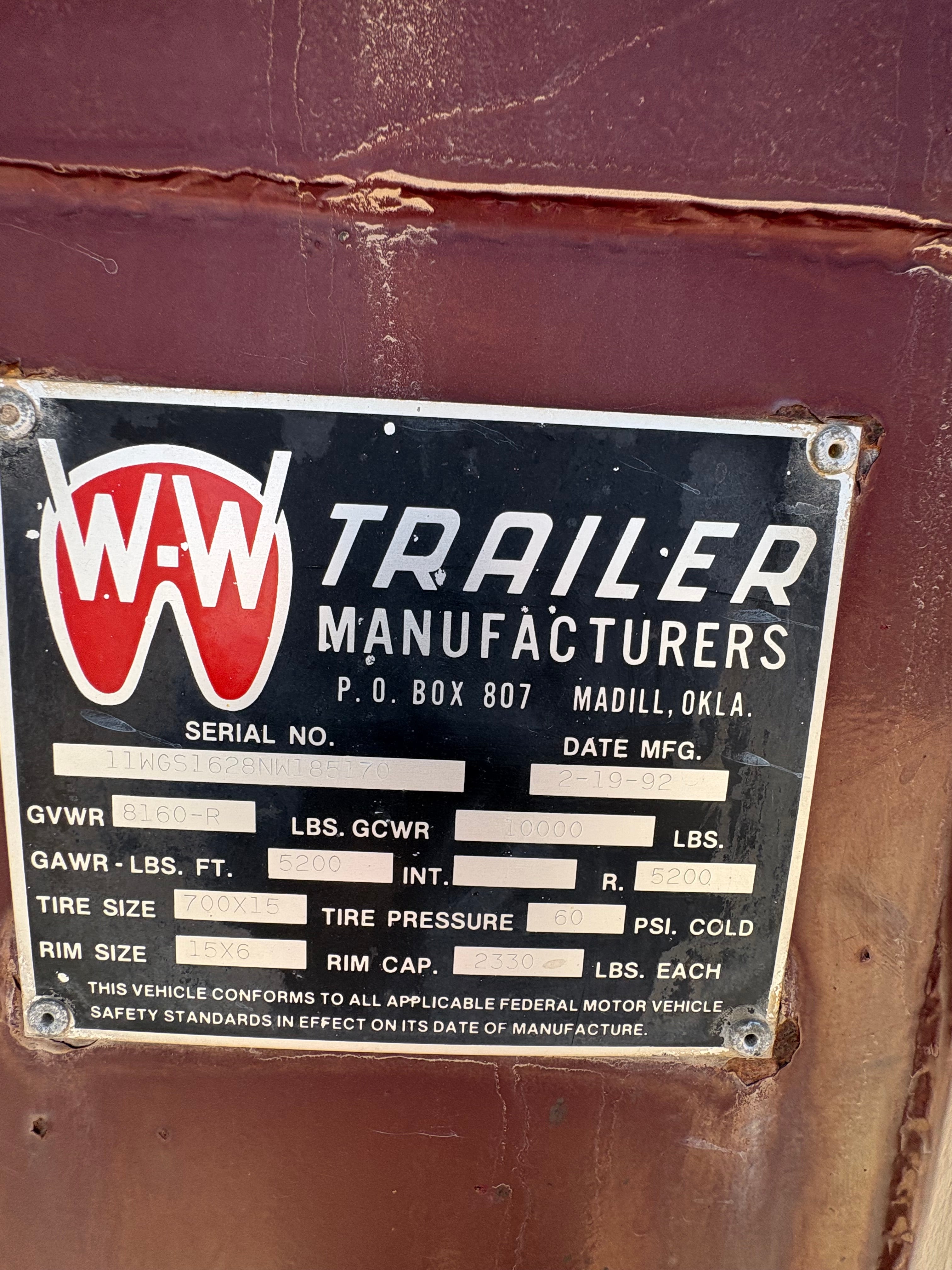 trailer manufacturer data plate showing serial number, GVWR 8160 lbs, tire size 700x15, and production date.