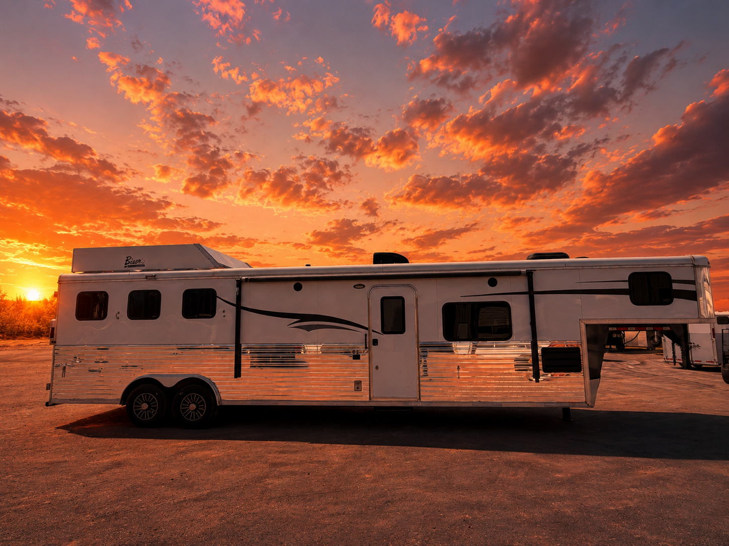 Living quarters horse trailer with gooseneck hitch parked at sunset, livestock trailer for ranch and rodeo transport.