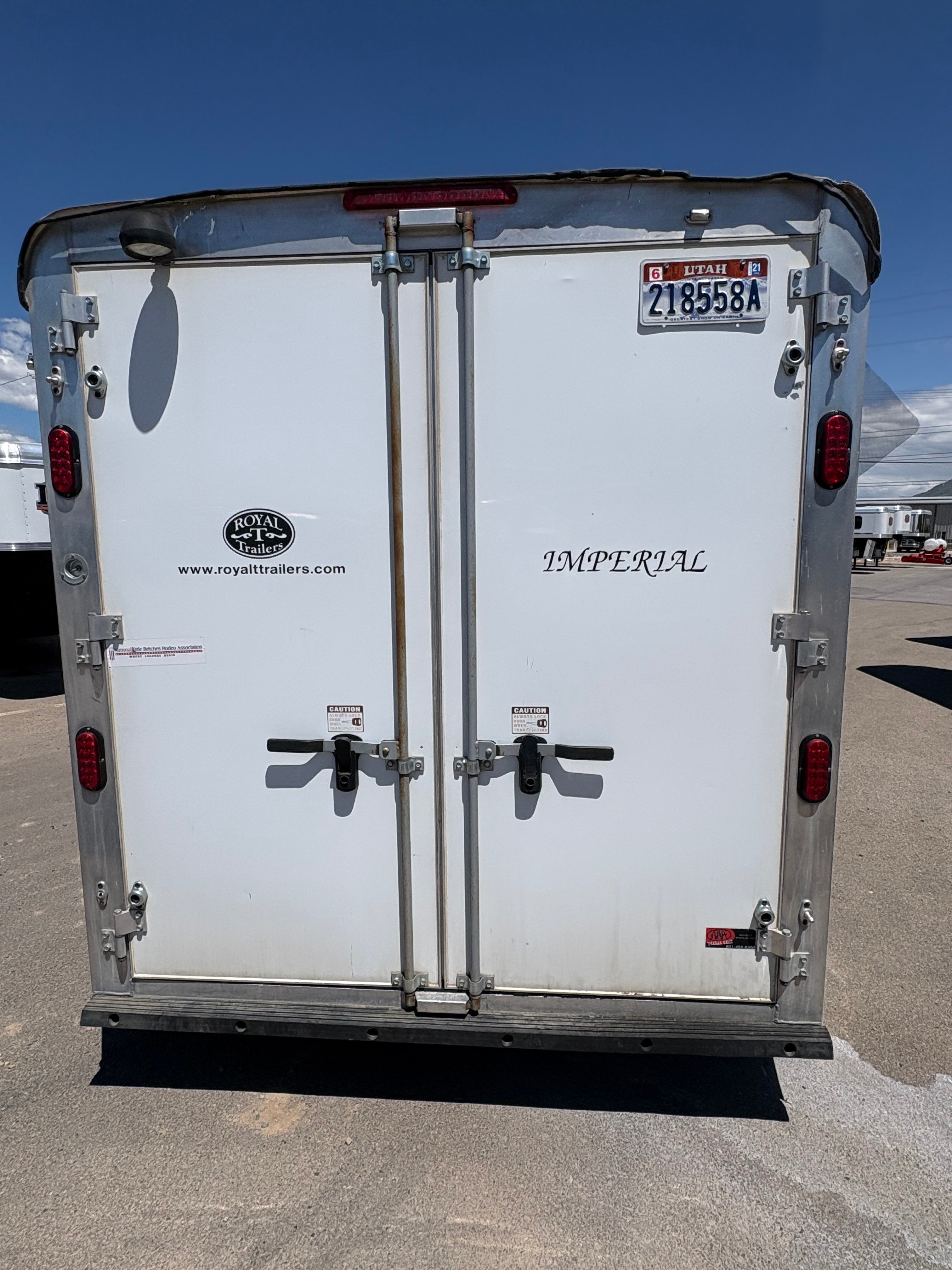 Rear double doors of 2013 Royal T 3 horse trailer with Royal T logo and Imperial model branding.