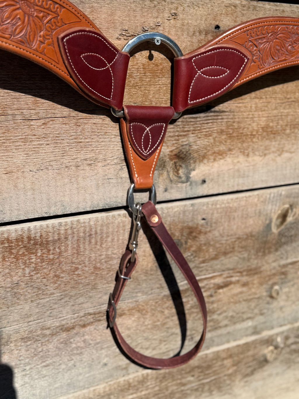 Shane Deater custom leather breast collar center ring and strap detail with stitched accents and hardware on western horse tack.