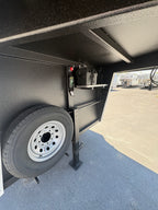 Gooseneck storage area of Logan Coach Bullseye XL trailer with spare tire and battery compartment.