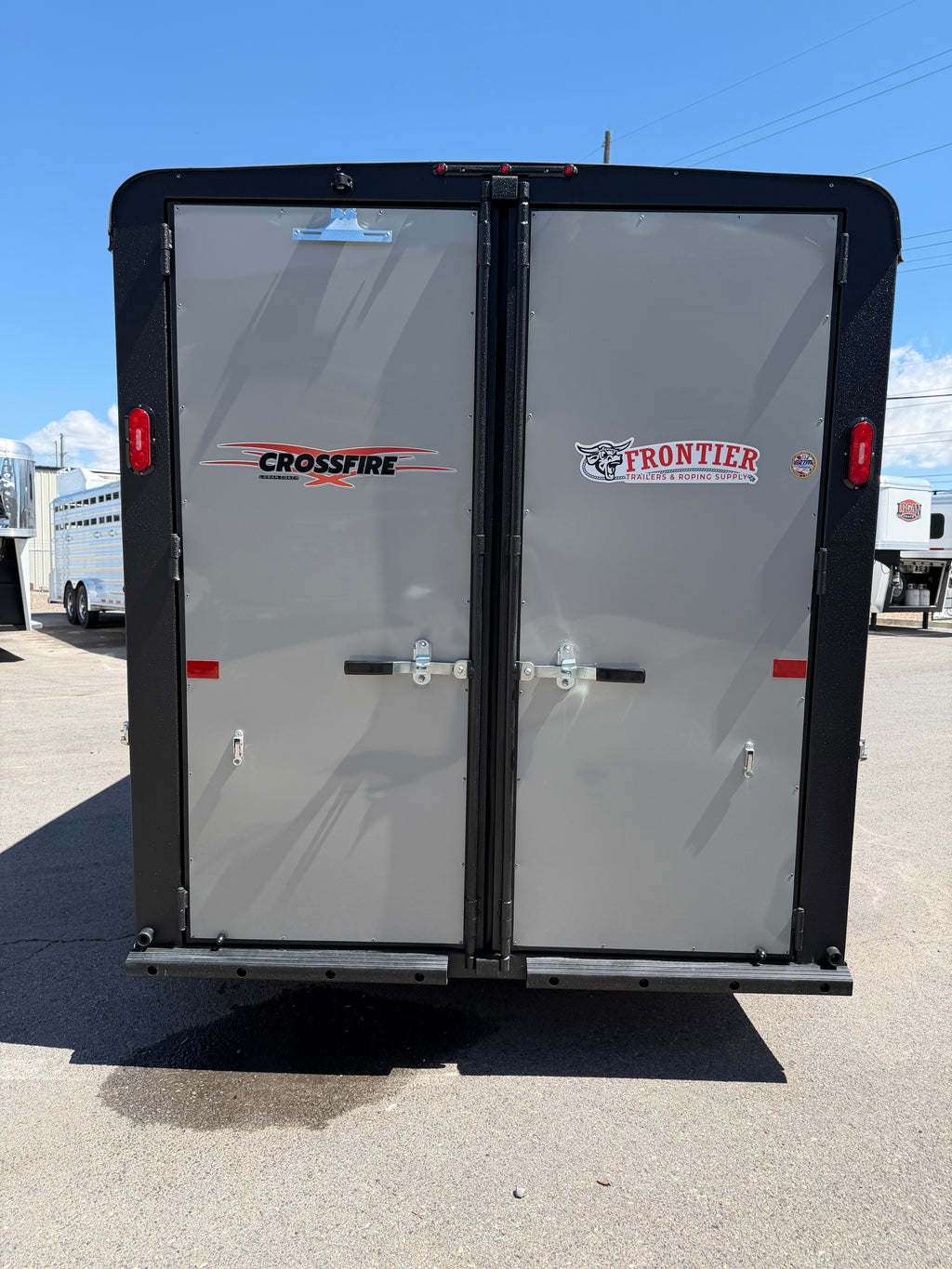 rear double loading doors on Logan Coach Crossfire 3 horse trailer with secure locking latches, Frontier Trailers branding, LED tail lights, and durable aluminum construction for horse transport.