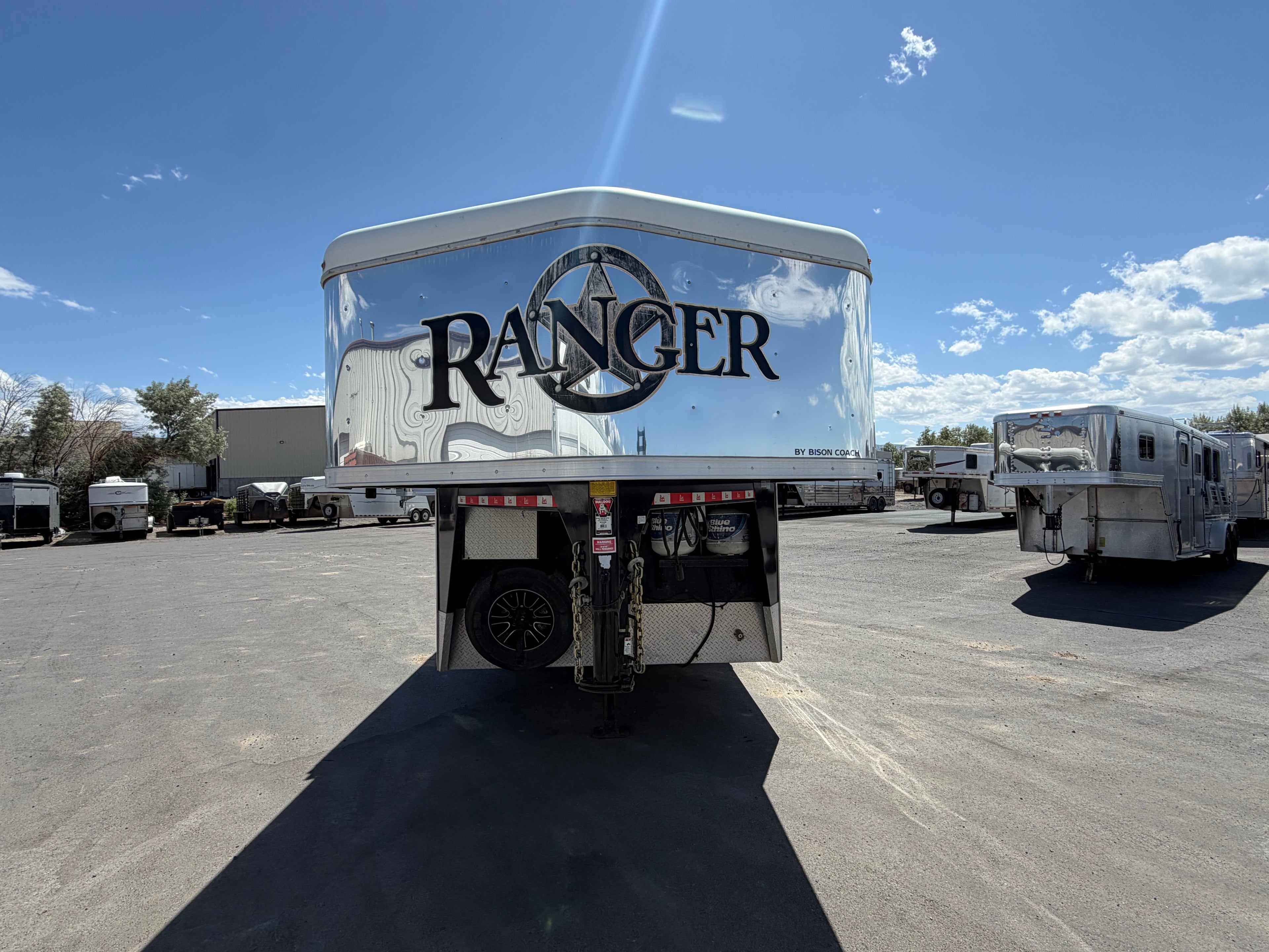 Ranger Bison horse trailer front view with gooseneck hitch parked in trailer lot, livestock trailer for ranch, rodeo, and horse transport