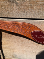Shane Deater custom leather breast collar close up with floral tooling and stitched two tone leather detail on western horse tack.