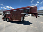 red gooseneck livestock trailer side view showing steel body, tack door, dual axles, and front nose window.