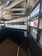 Logan Coach 26 stock combo trailer interior side wall with aluminum panels, livestock vents and gate hardware for horse and cattle transport.