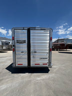 Logan Coach 26 stock combo trailer rear view with double doors, aluminum panels and latch hardware parked in trailer lot.