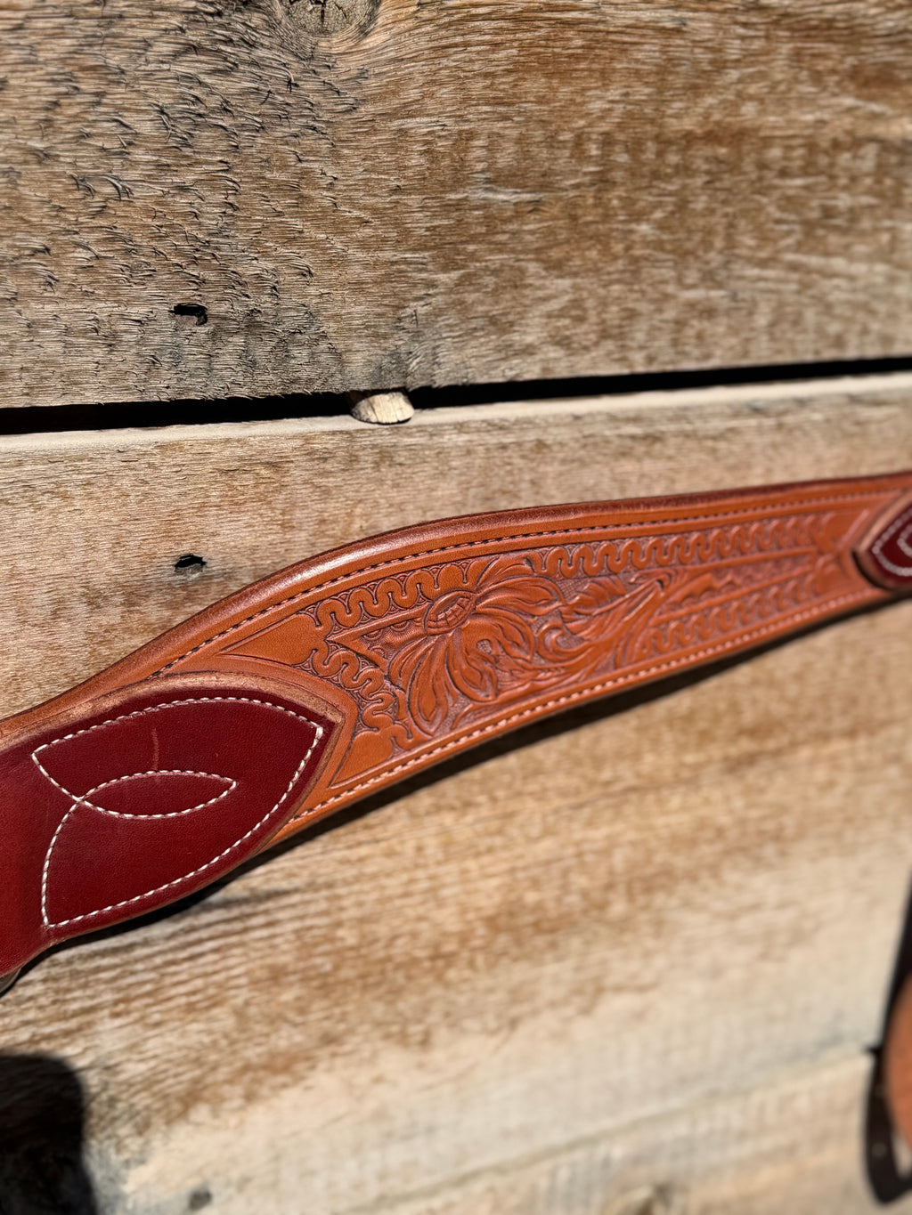 Shane Deater custom breast collar detailed view showing floral tooled leather pattern and stitched accent on western horse tack.
