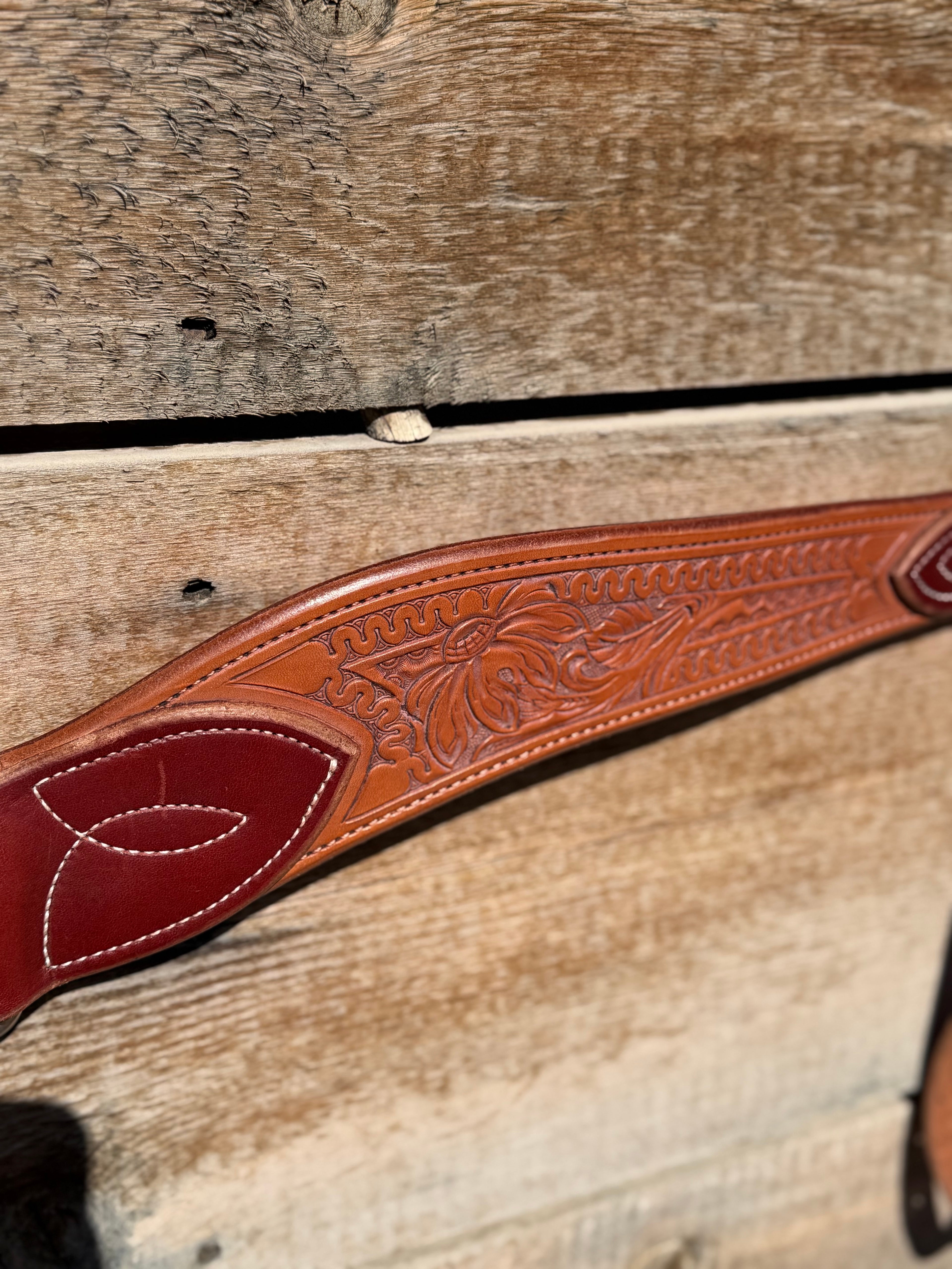 Shane Deater custom breast collar detailed view showing floral tooled leather pattern and stitched accent on western horse tack.