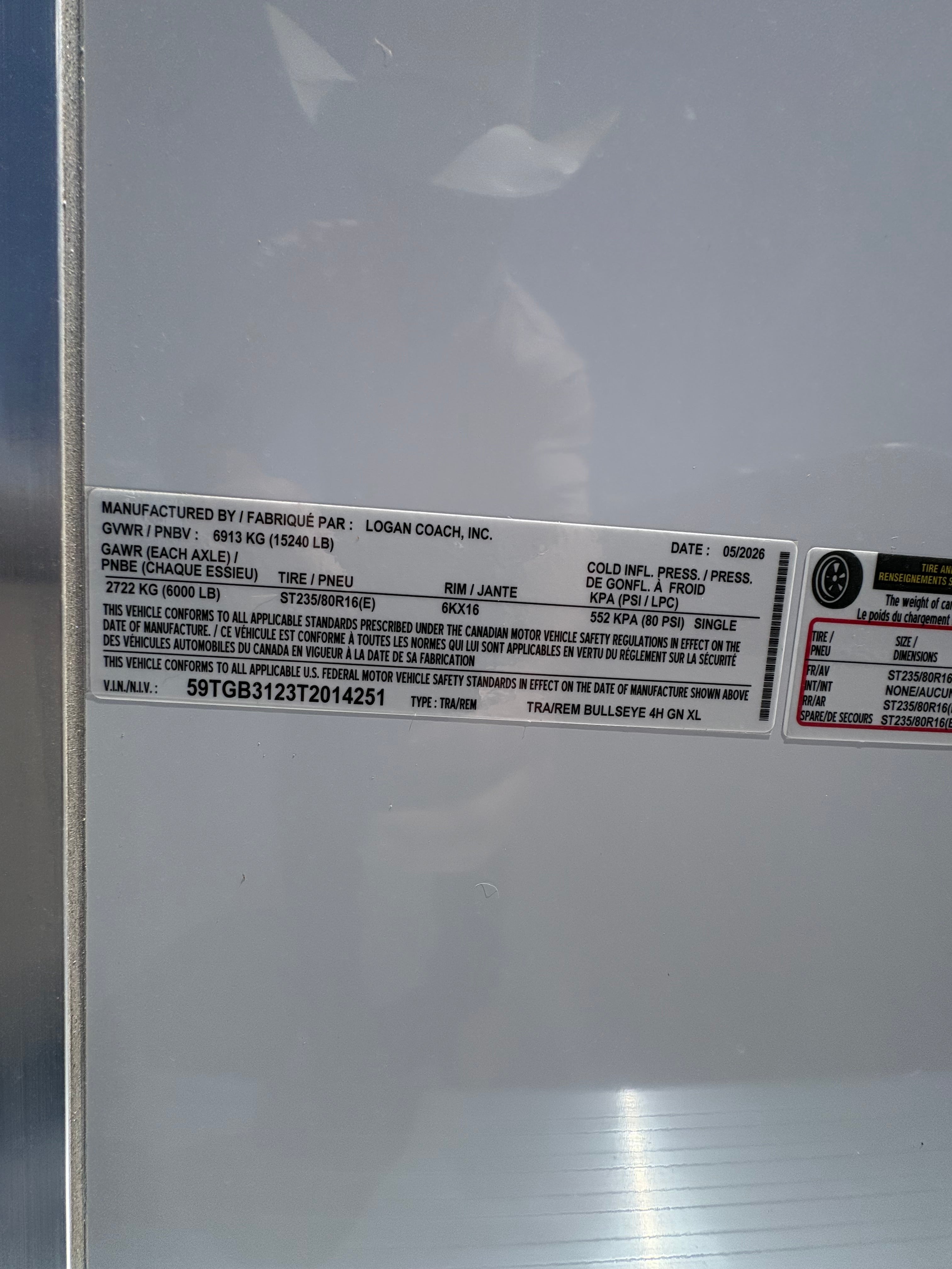 Logan Coach Bullseye XL 4 horse trailer manufacturer label with VIN and specifications plate.