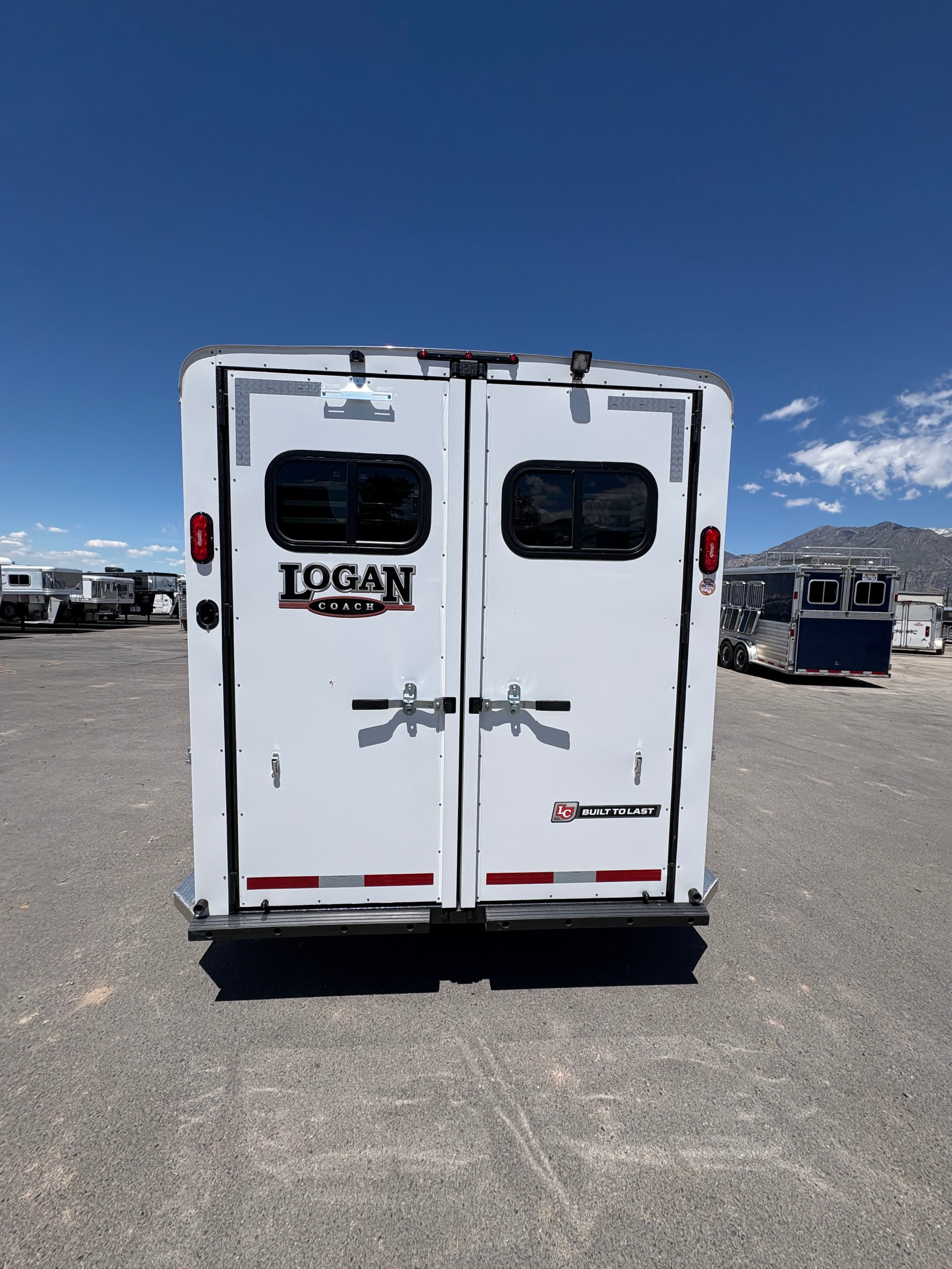 Logan Coach Bullseye XL 4 horse trailer rear double doors with windows and latch hardware.