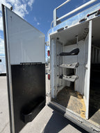 Horse trailer rear tack room with saddle racks and storage, livestock trailer gear compartment for ranch and rodeo use.
