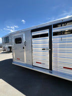 Logan Coach 26 stock combo trailer side detail with aluminum panels, livestock vents and access door on gooseneck horse trailer.