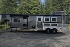 A horse trailer parked in a lot at Frontier Trailers & Roping Supply, showcasing its sturdy design and functionality.